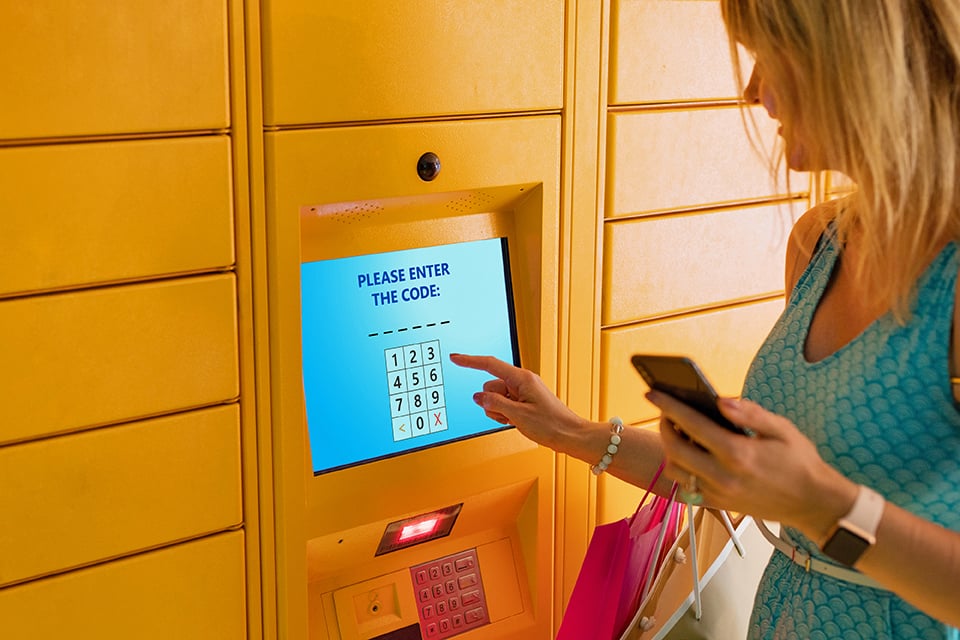 BOPIS Click and collect customer woman at locker package code pickup retail shopping