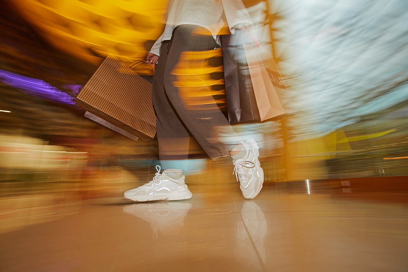 retail rollout shopper in retail store bags blurry