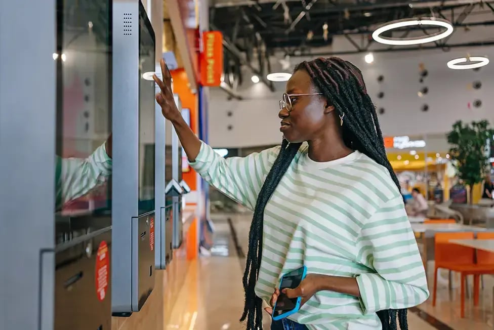 Experiential Retail Is Maturing-Woman using touchscreen