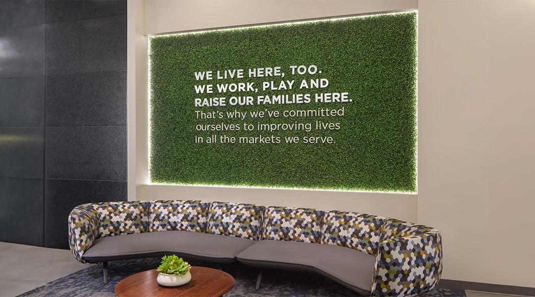 grass wall with a backlit quote for a bank design