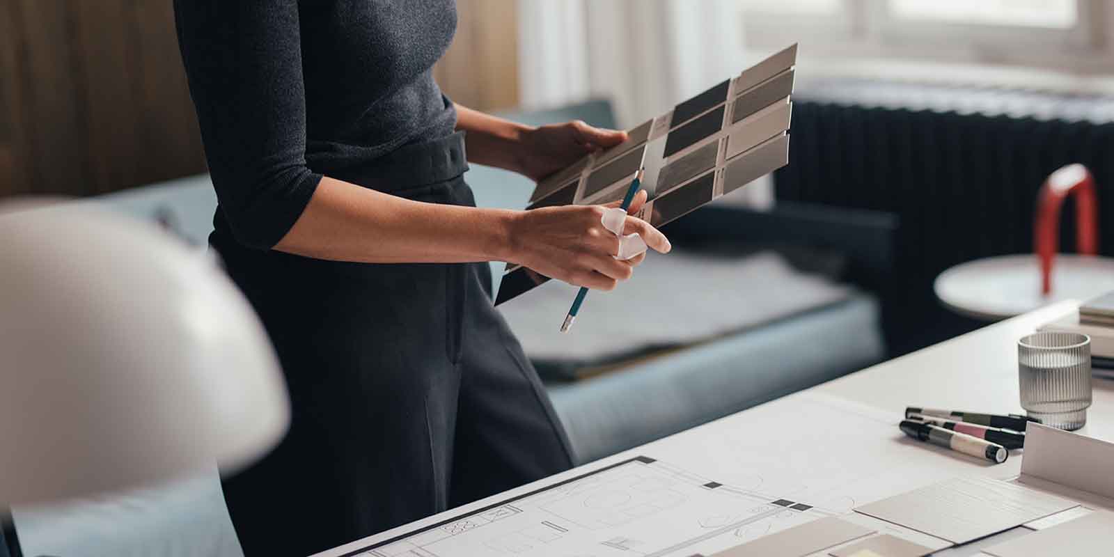 creative director holding art samples in hand