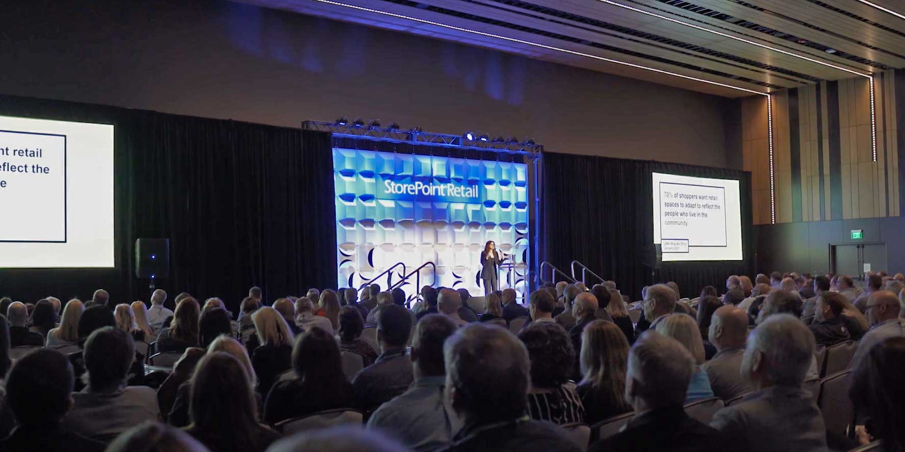 Store Point Retail 2021 Conference in session woman on stage speaking with audience
