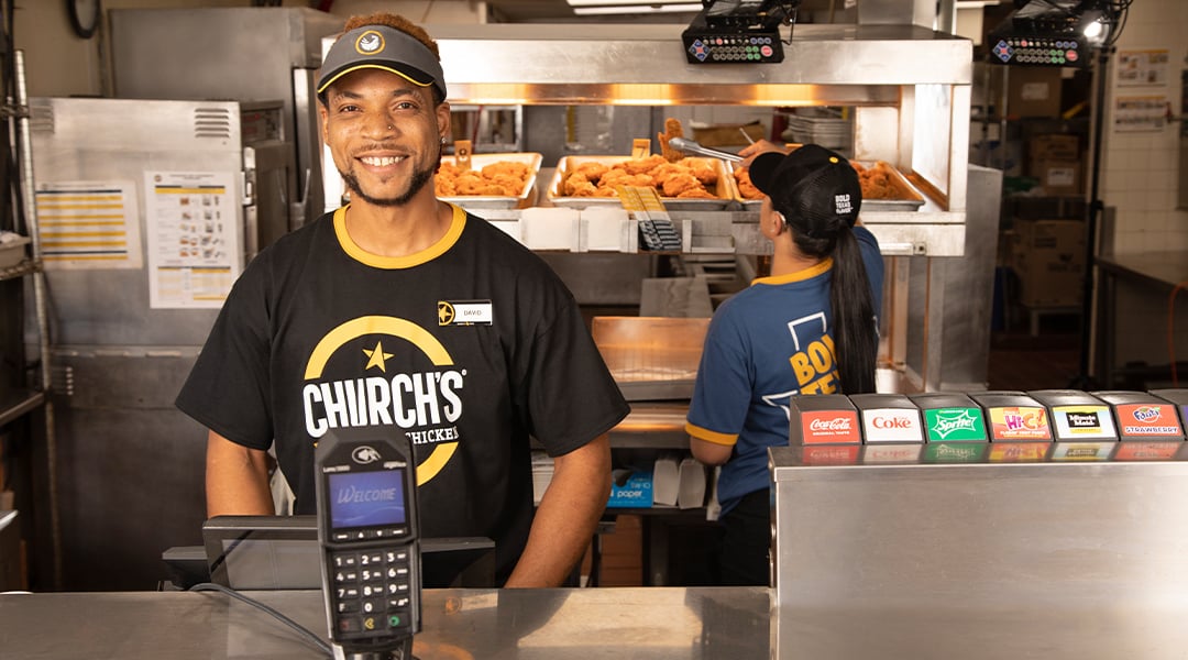 happy restaurant worker with a branded shirt