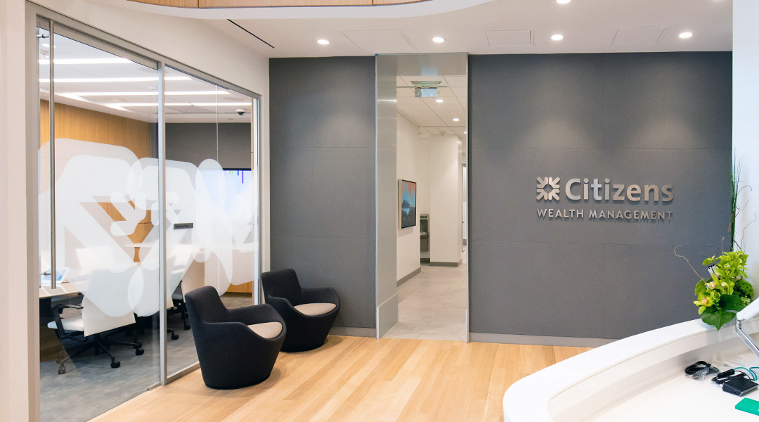 bank branch lobby redesigned in light woods and grey walls with 3D signage