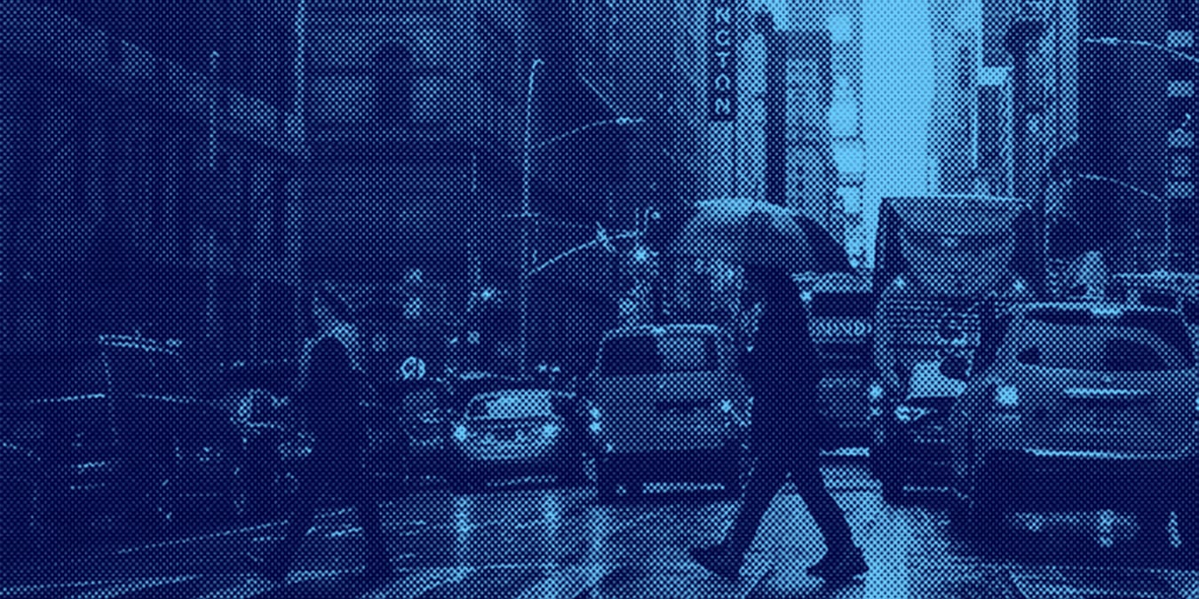 New York City Person with umbrella walking at crosswalk