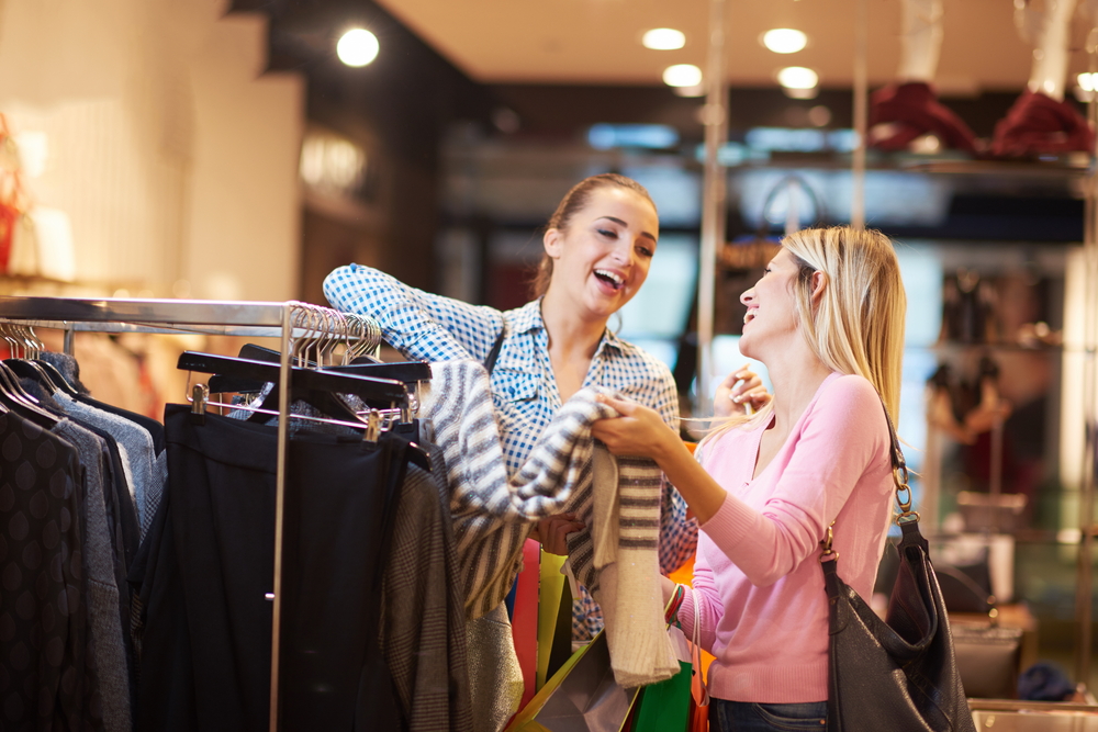 happy young girls in  shopping mall, friends having fun together